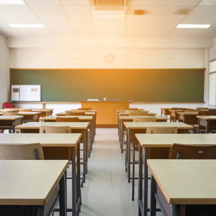 Empty classroom with desks facing a board