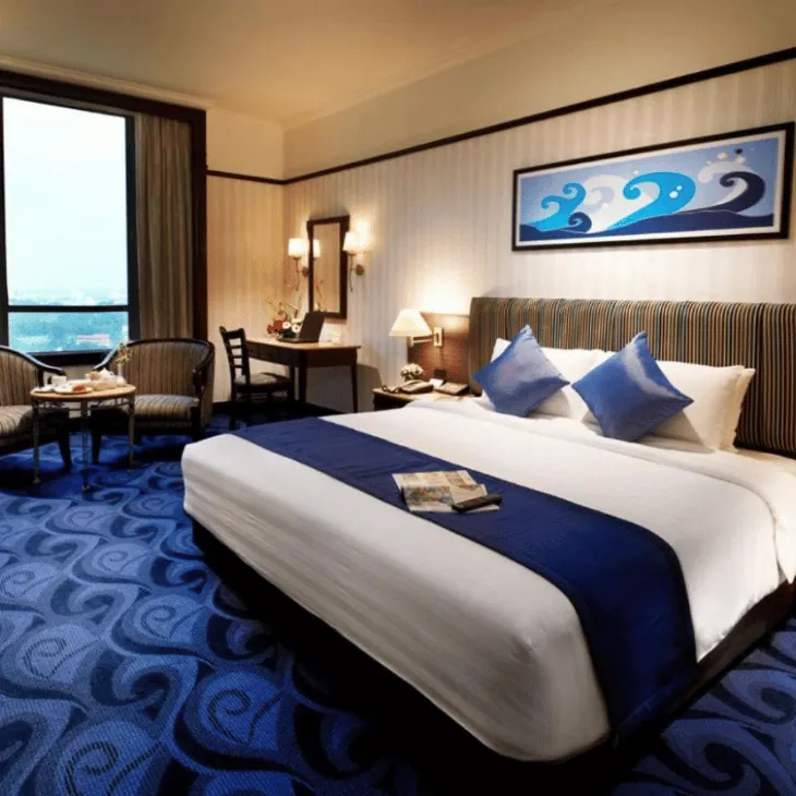 Neatly made hotel room with a large bed