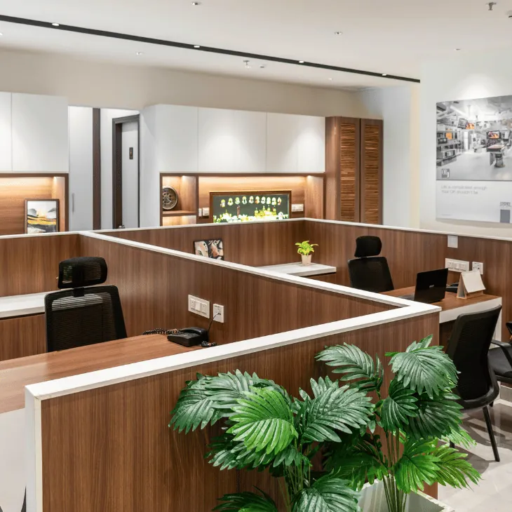 Modern open-plan office with wooden workstations and plants
